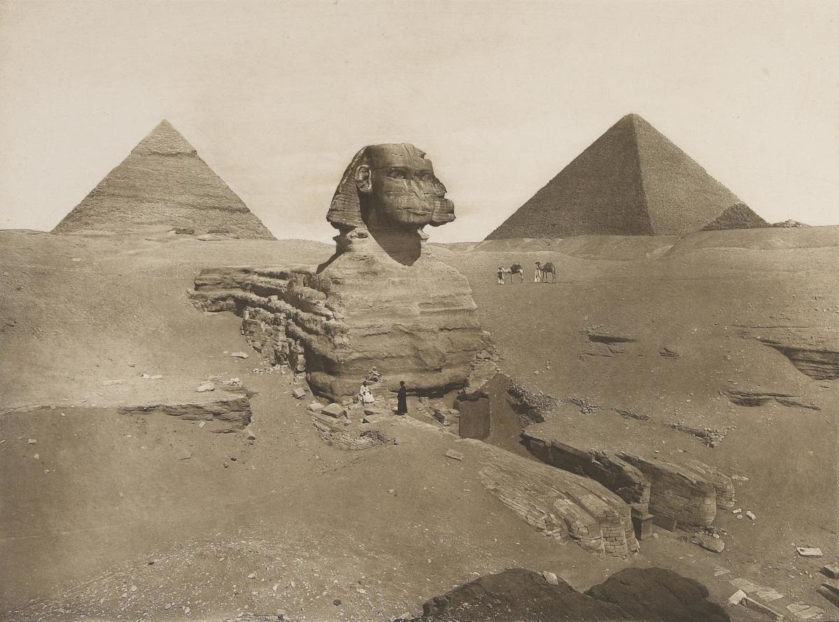 The partially excavated Sphinx is shown from the South East with the head between the pyramids of Khafre and Khufu.